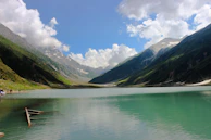 A body of water with mountains in the background