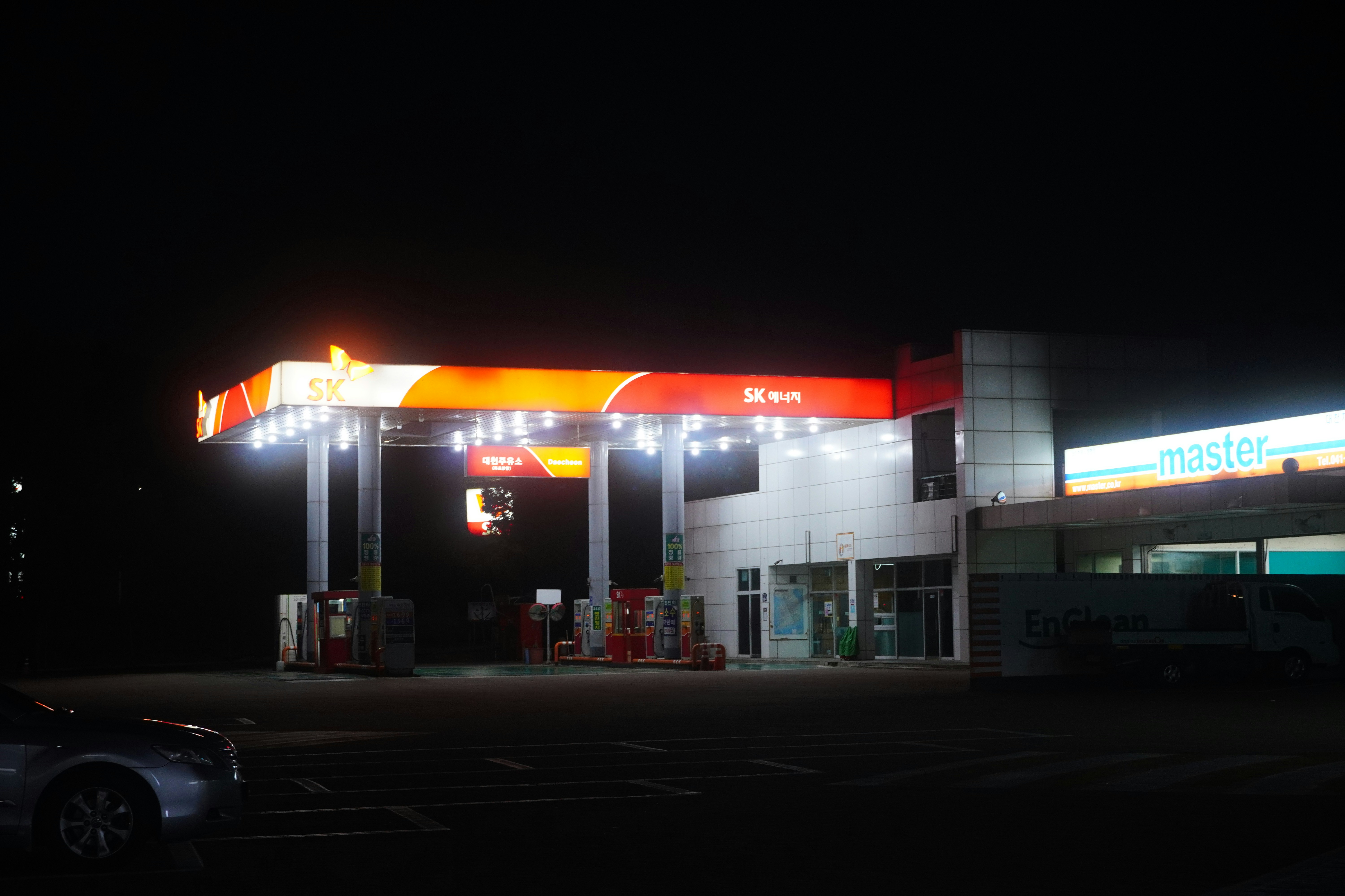 A gas station lit up at night time