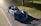 A blue sports car is parked on the side of the road