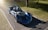 A blue sports car is parked on the side of the road
