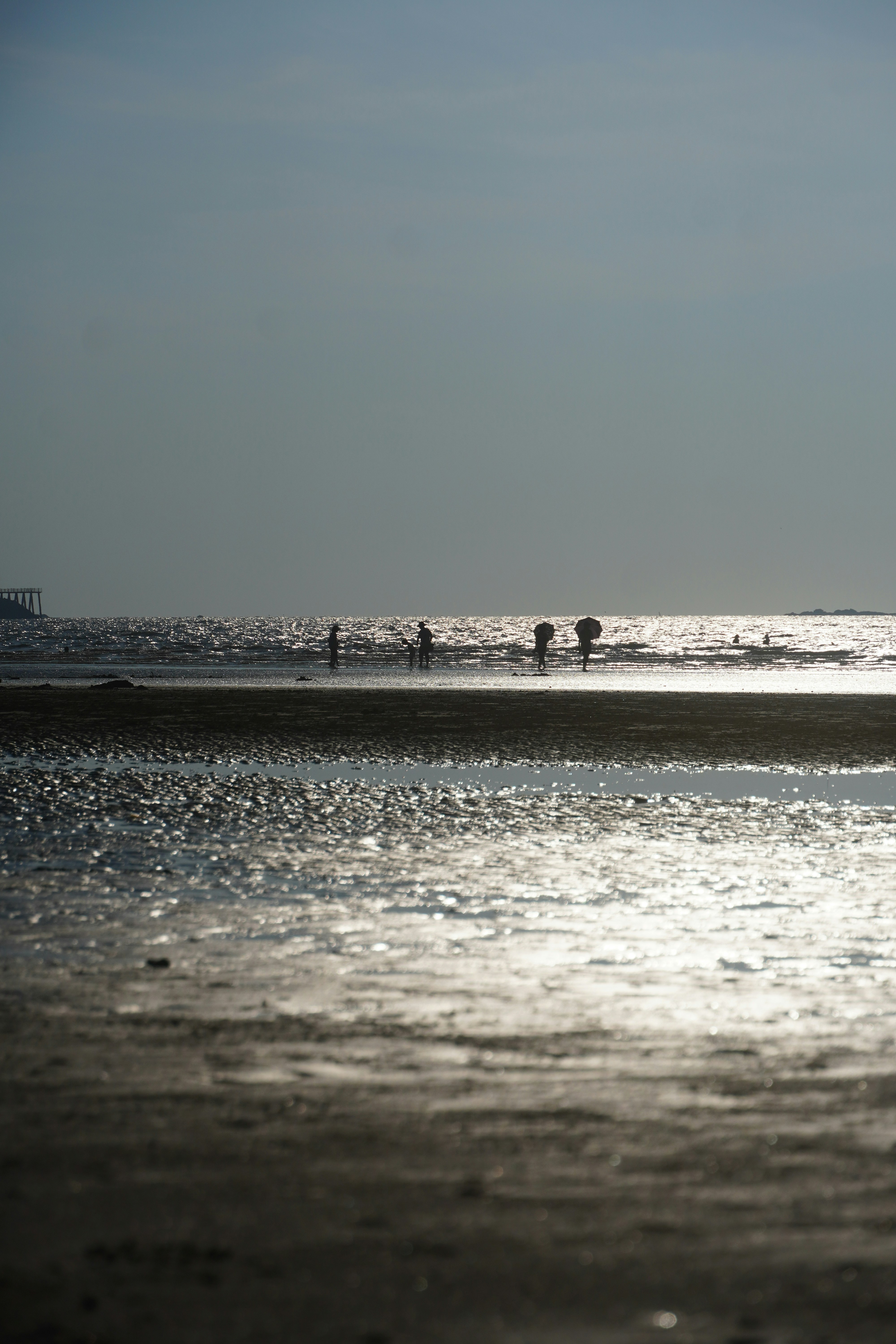 A group of people standing on top of a beach