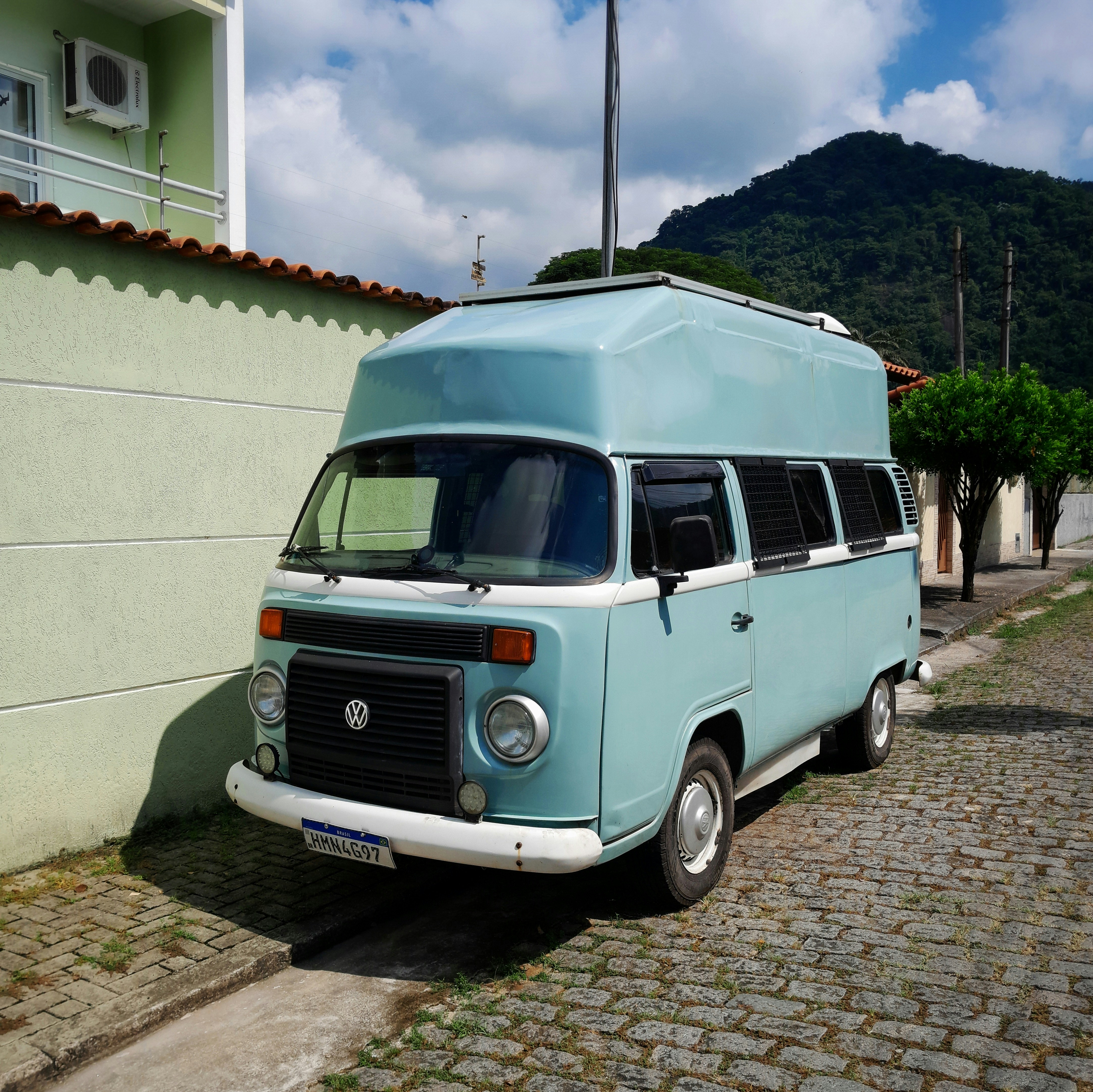 A blue van parked on the side of a road
