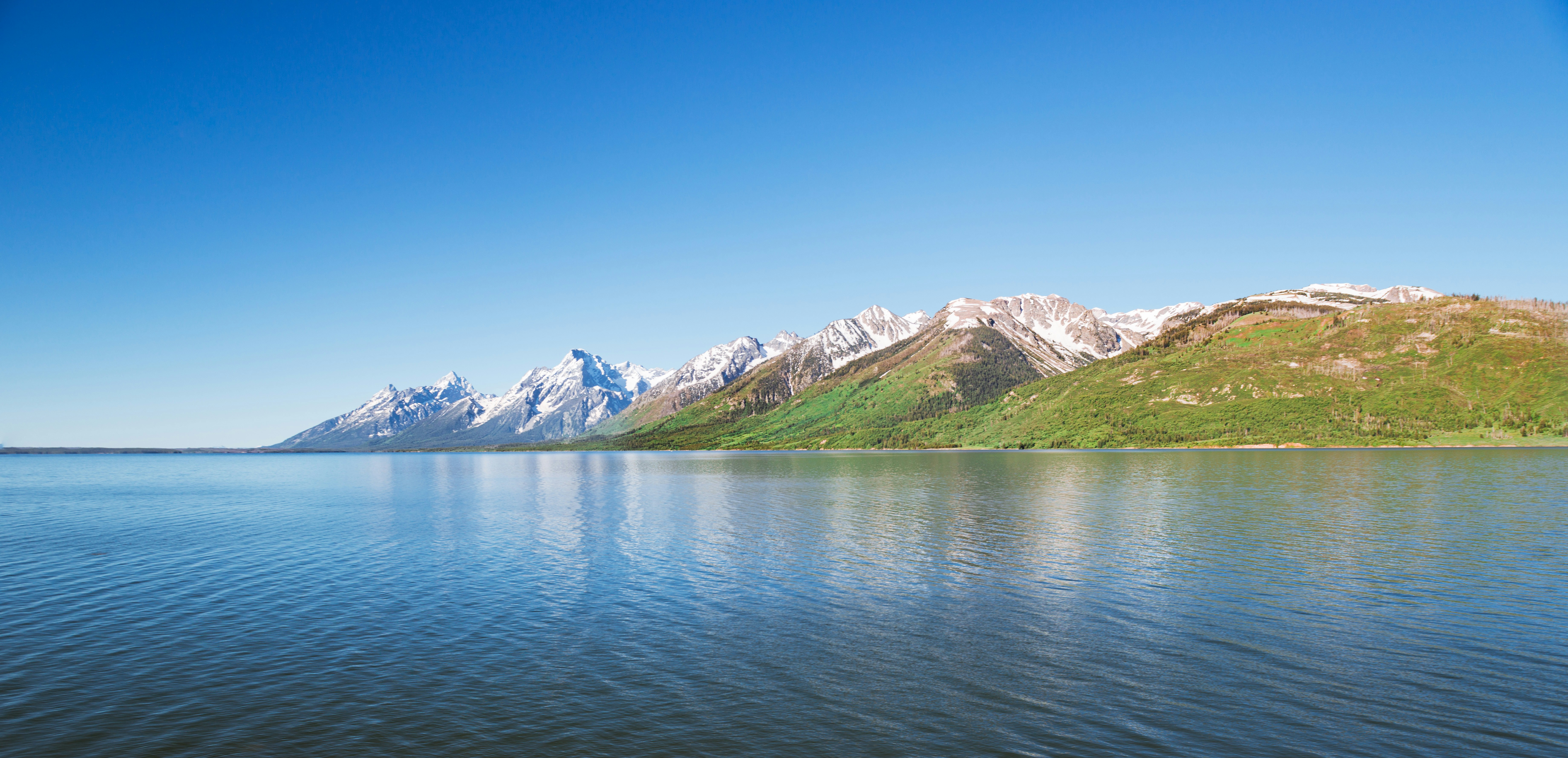 A large body of water with mountains in the background