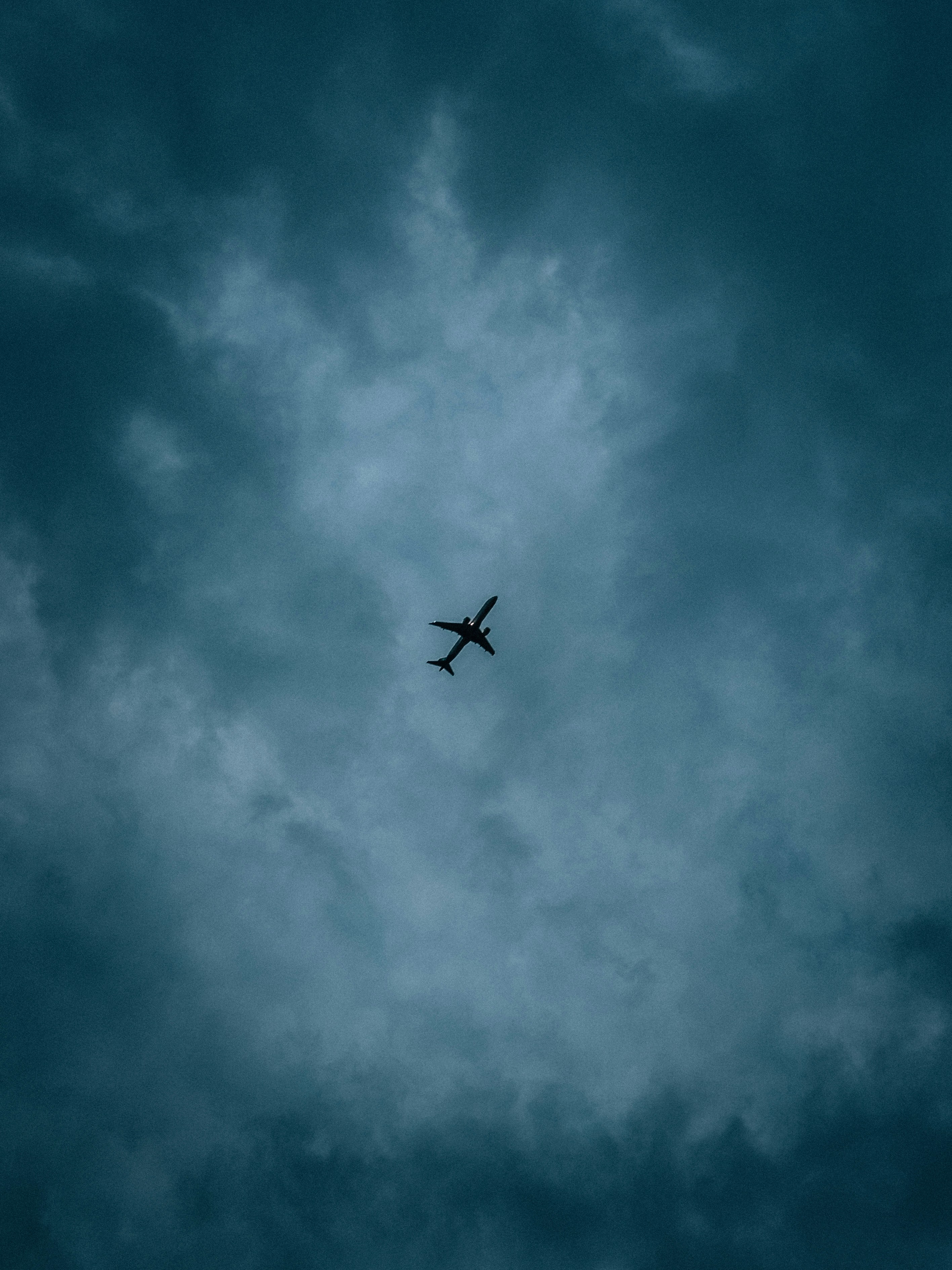 An airplane is flying through a cloudy sky