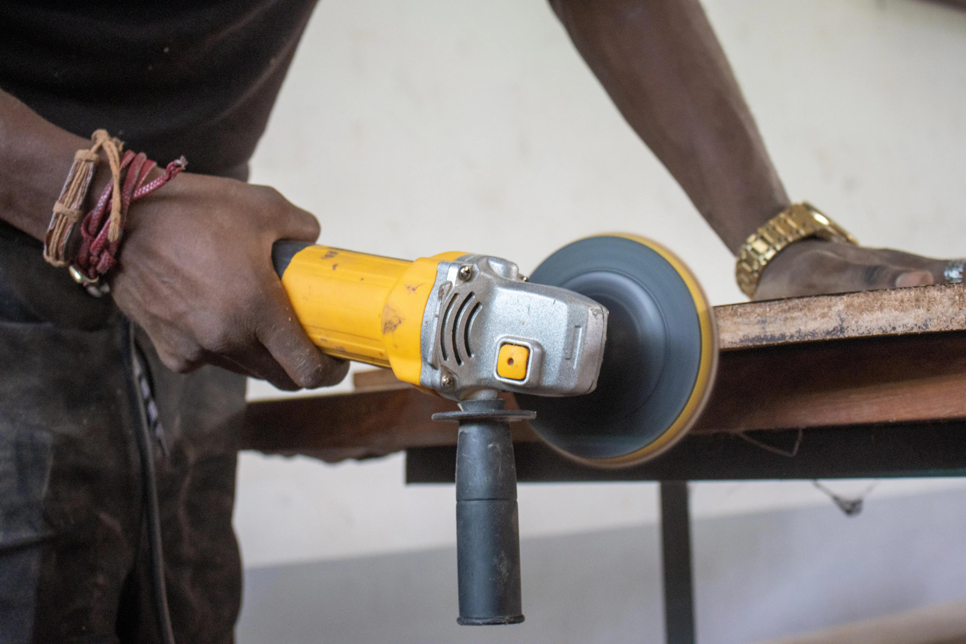 A man using a power tool on a piece of wood