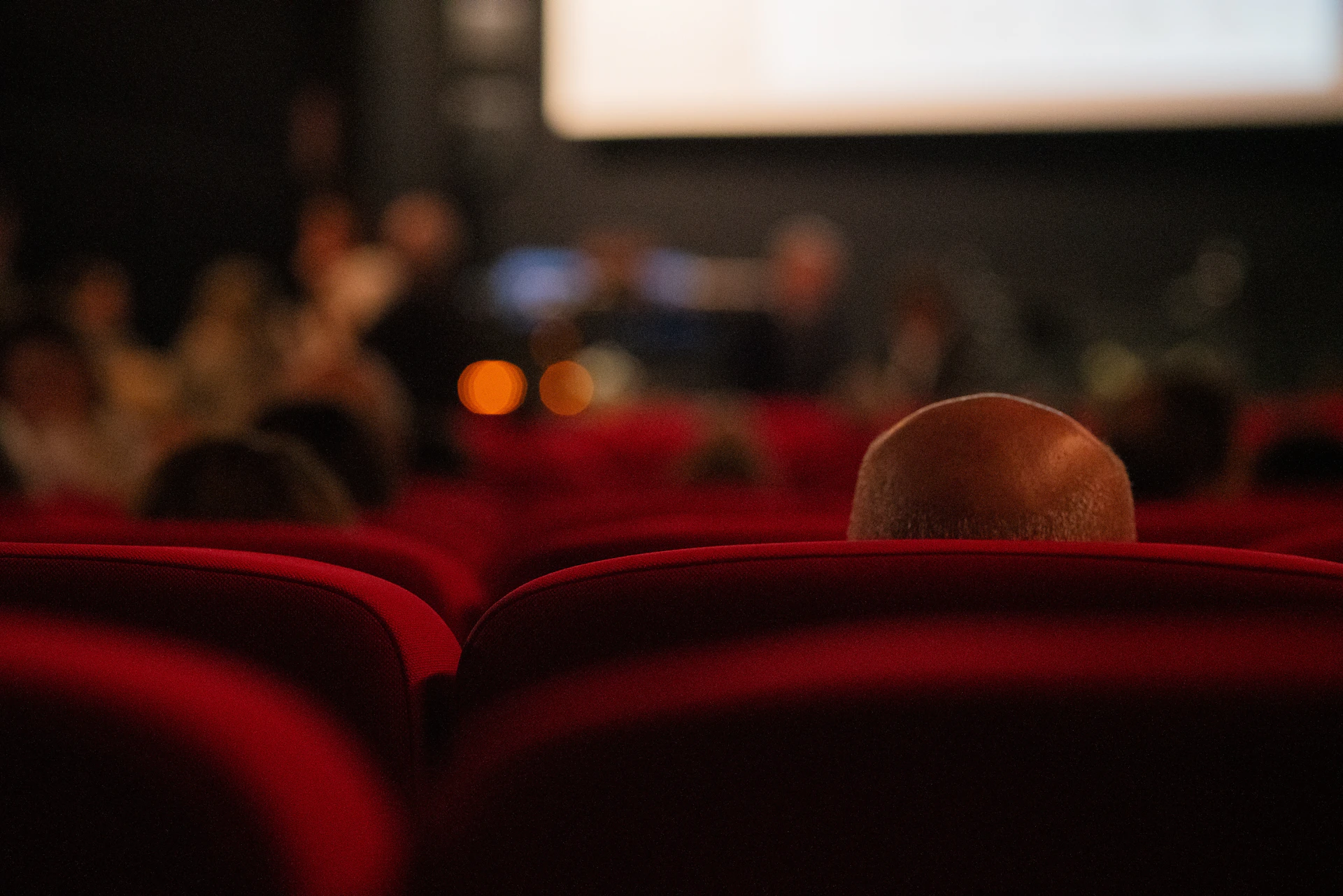 A blurry photo of people in a movie theater
