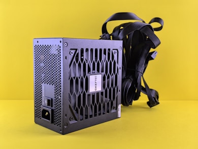A black computer case sitting on top of a yellow surface