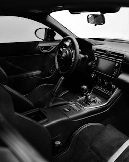 A black and white photo of the interior of a car