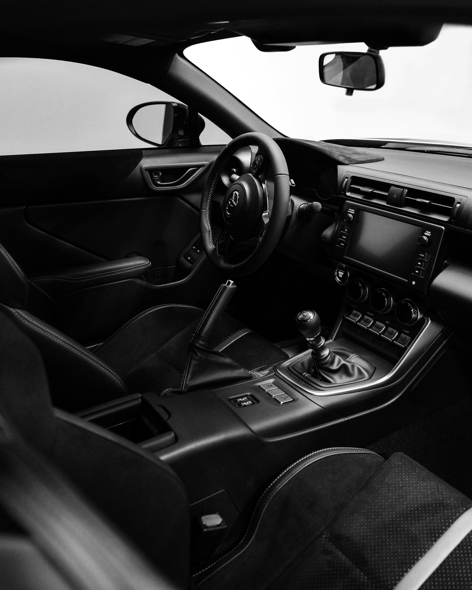 A black and white photo of the interior of a car