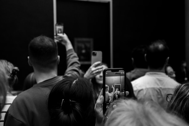 A group of people taking pictures of themselves in a mirror