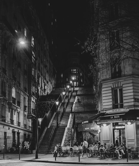 A black and white photo of a city street at night