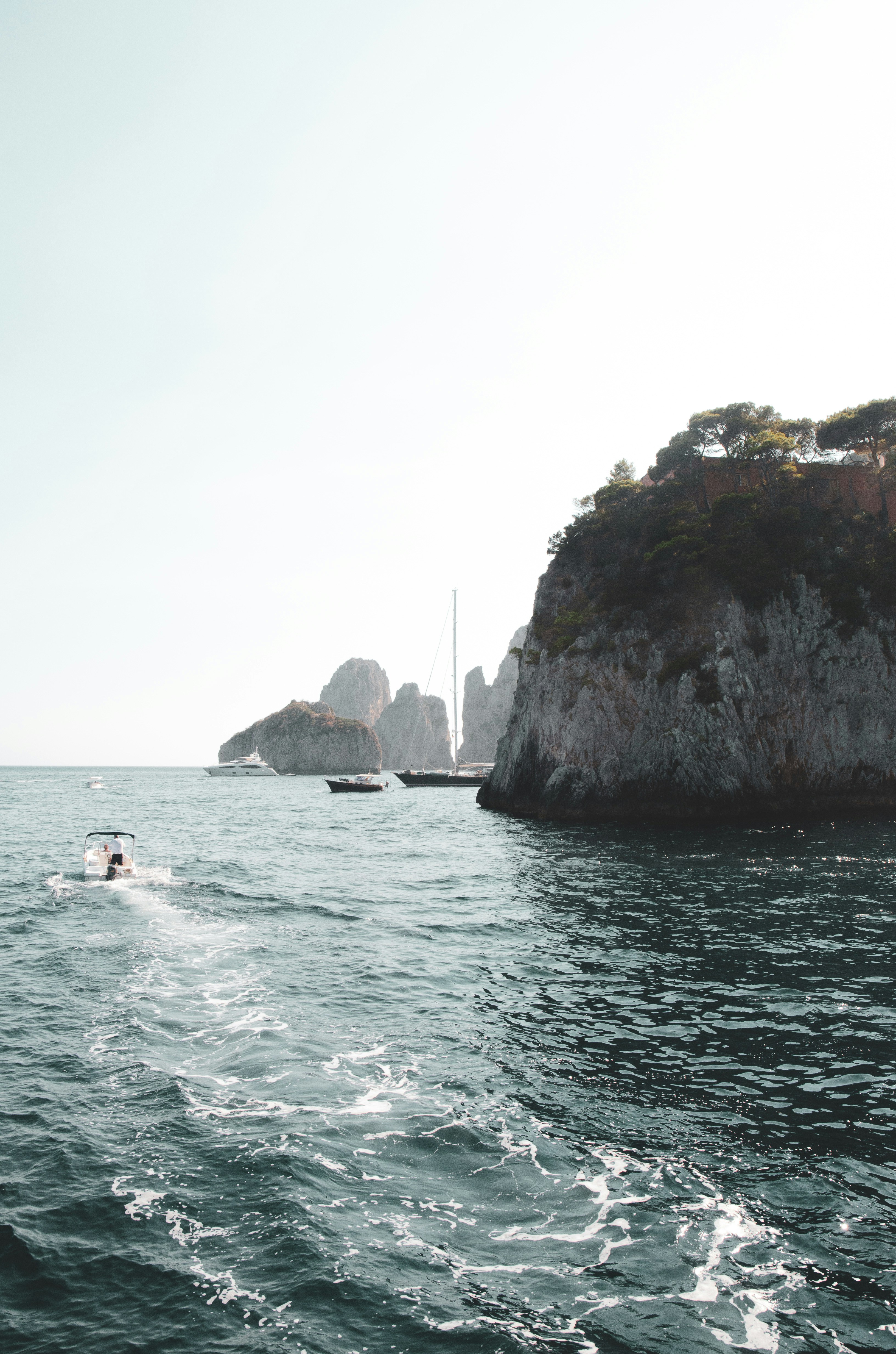 A group of people riding on top of a boat in the ocean