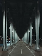A car driving under a bridge at night