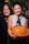 Two women holding a tray of food in their hands