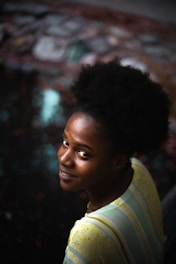 A woman with a striped shirt is smiling