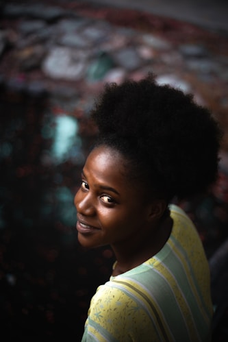 A woman with a striped shirt is smiling