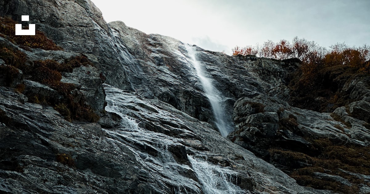 A very tall waterfall with a sky background photo – Free Waterfall ...
