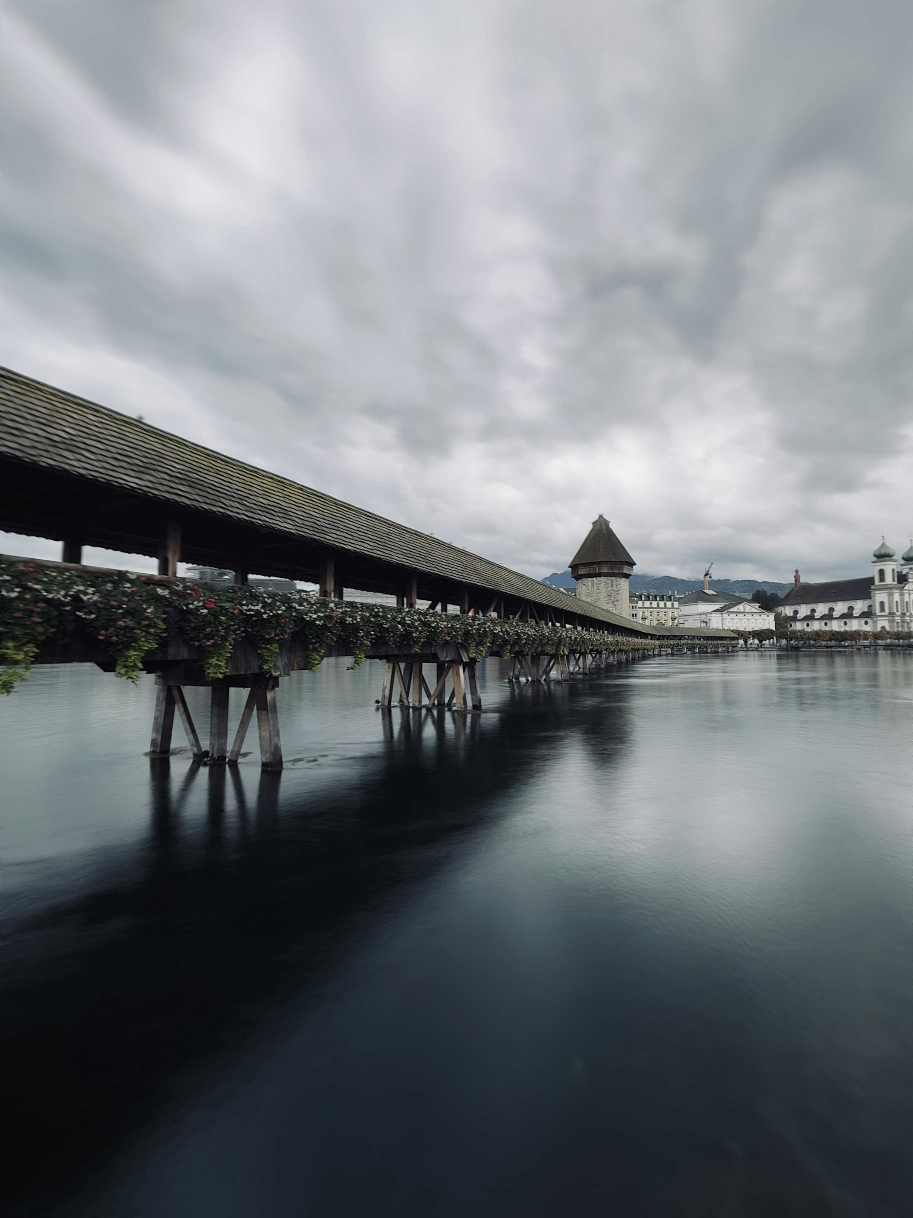 A long exposure photo of a bridge over a body of water