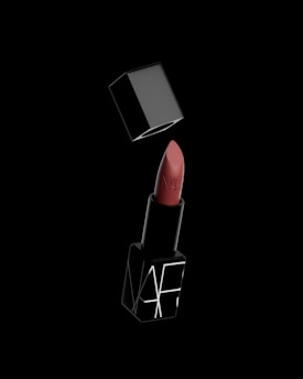 A red lipstick with a black background