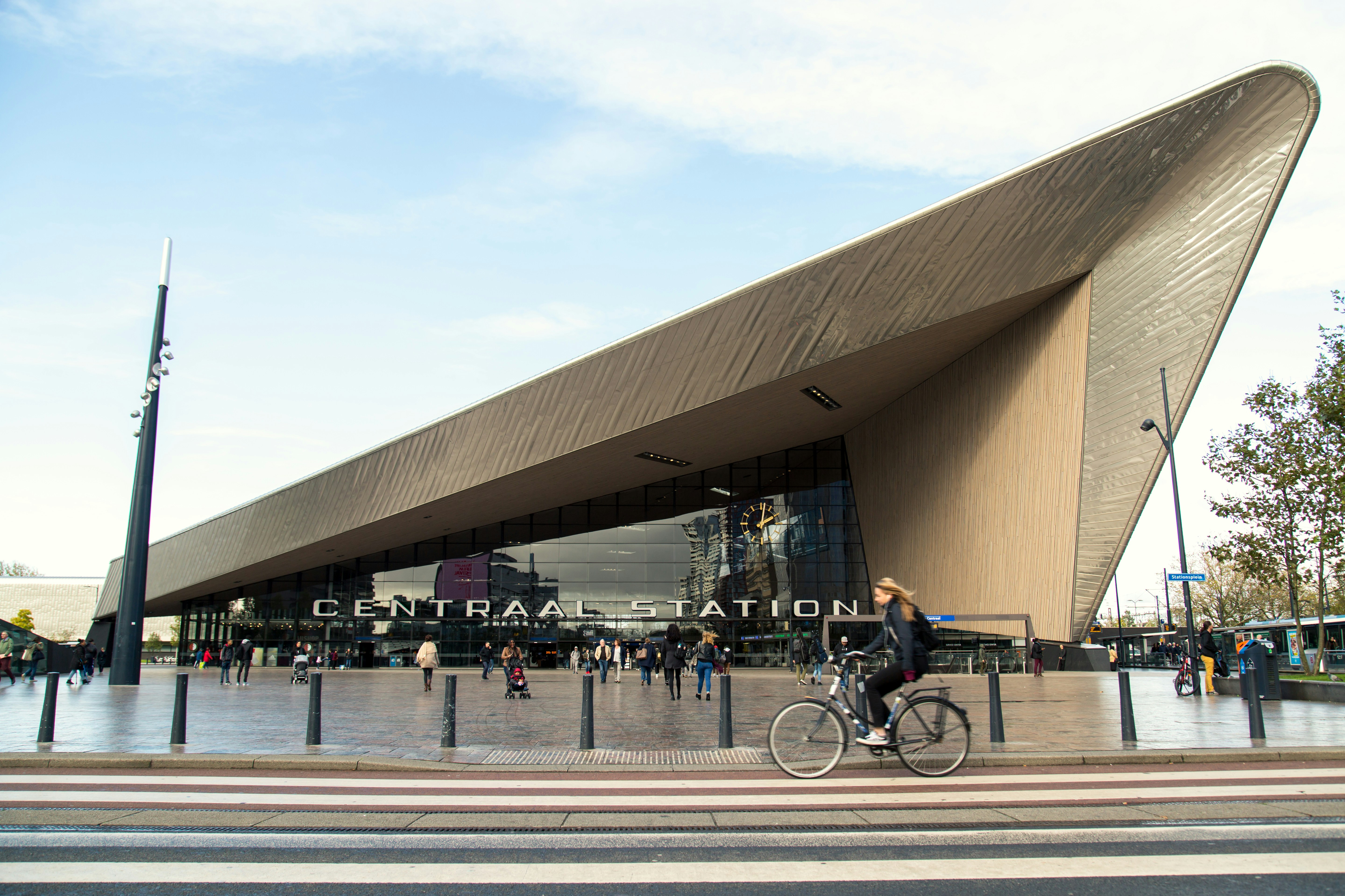 Eine Person, die mit dem Fahrrad vor einem Gebäude fährt