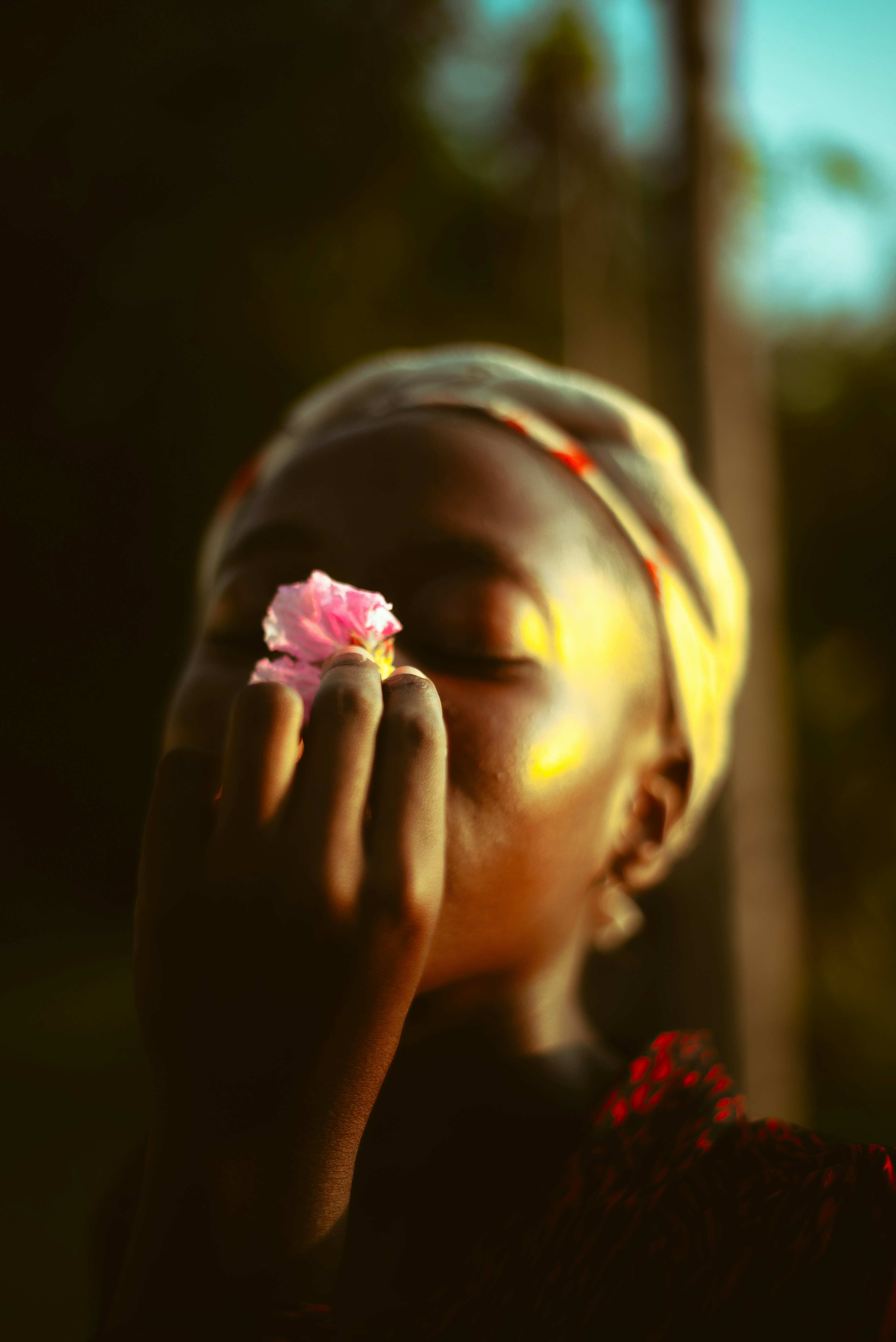 A little girl holding a flower in her hand