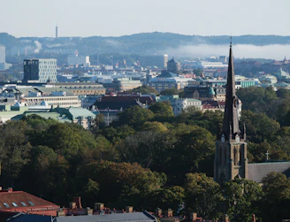 A city skyline with a church steeple in the foreground