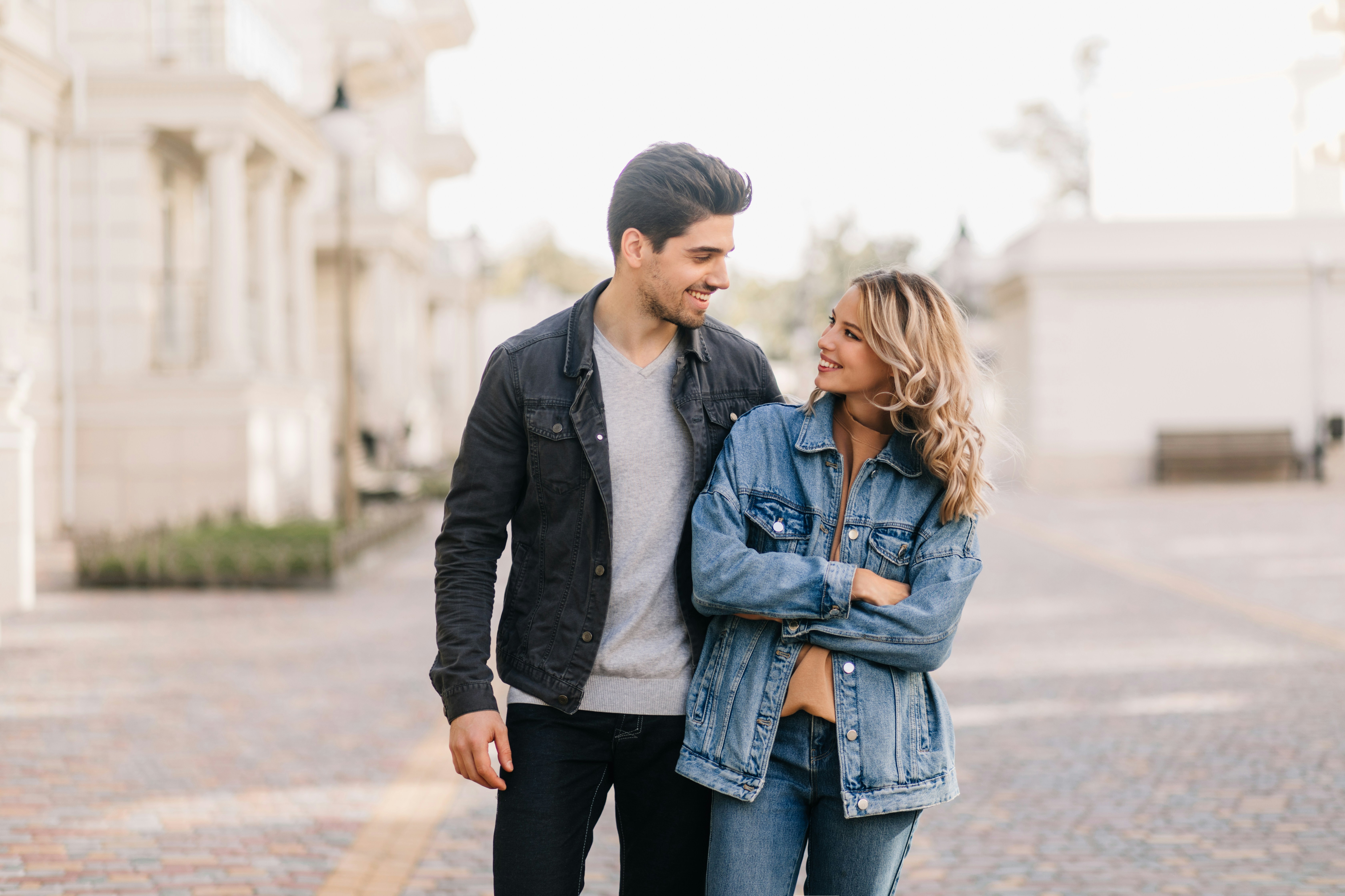A man and a woman walking down a street