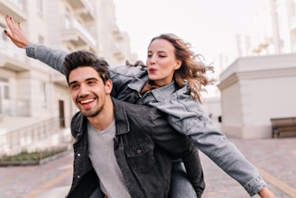 A man carrying a woman on his back