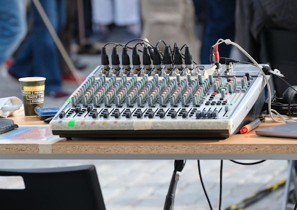 A table that has a bunch of electronic equipment on it