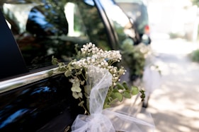 A bouquet of flowers sitting on the back of a car