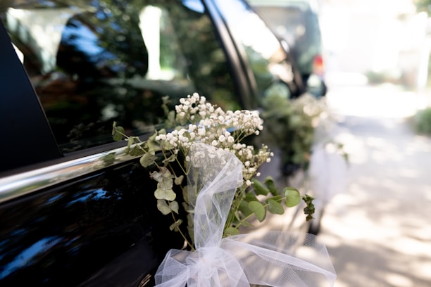 A bouquet of flowers sitting on the back of a car