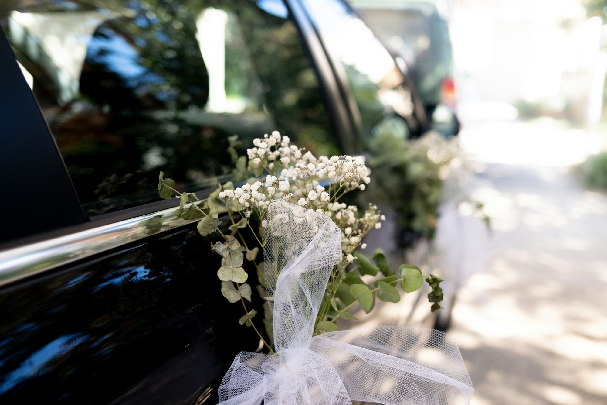A bouquet of flowers sitting on the back of a car