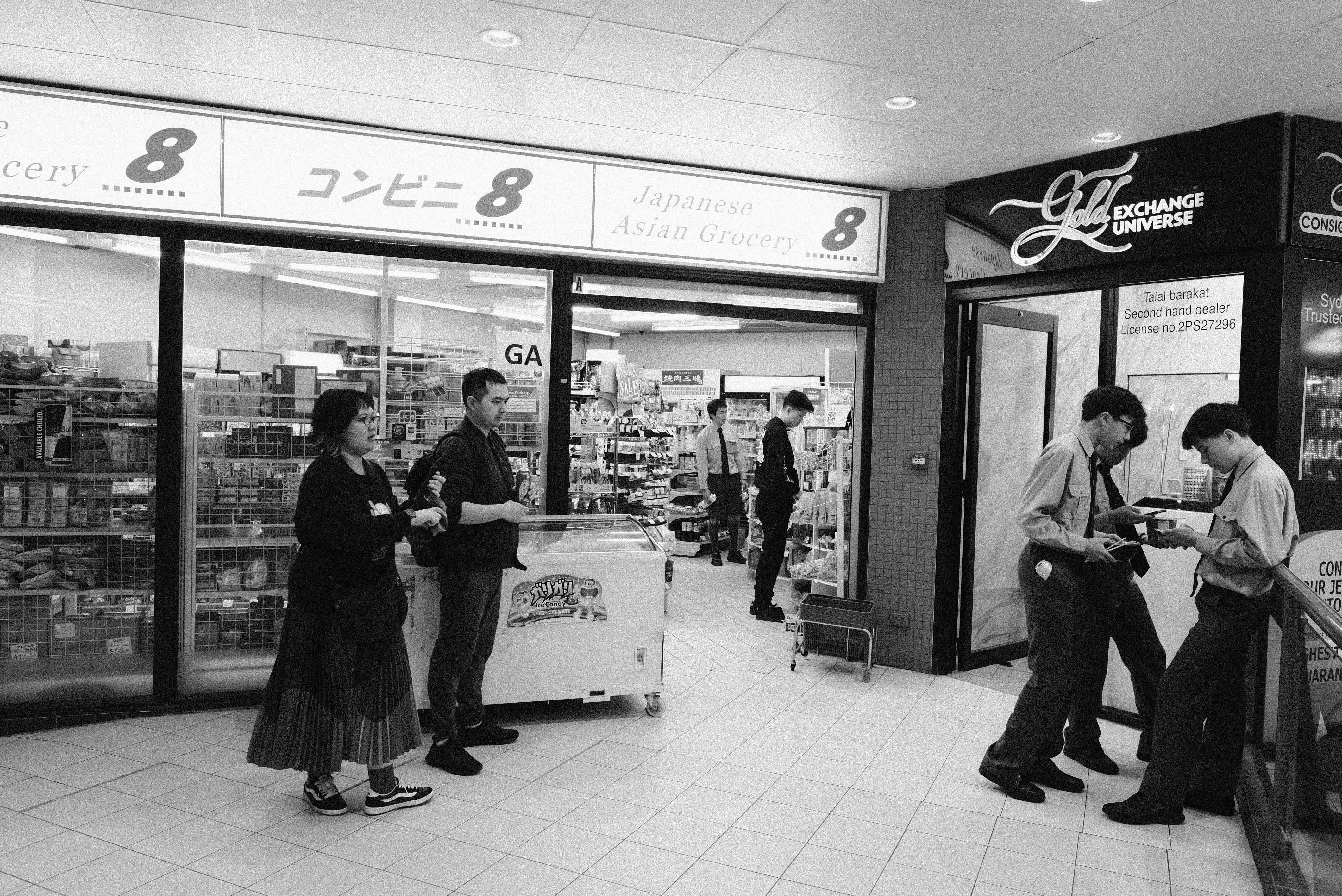 A black and white photo of people in a store