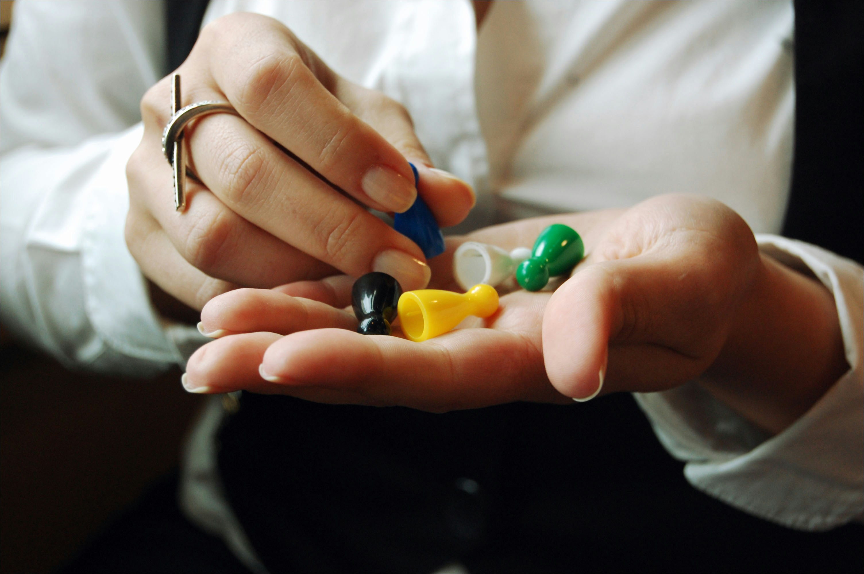 A person holding a small group of pills in their hands