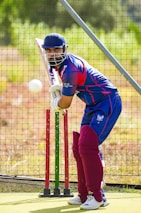 A man hitting a ball with a bat