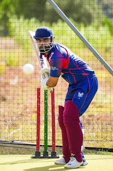 A man hitting a ball with a bat
