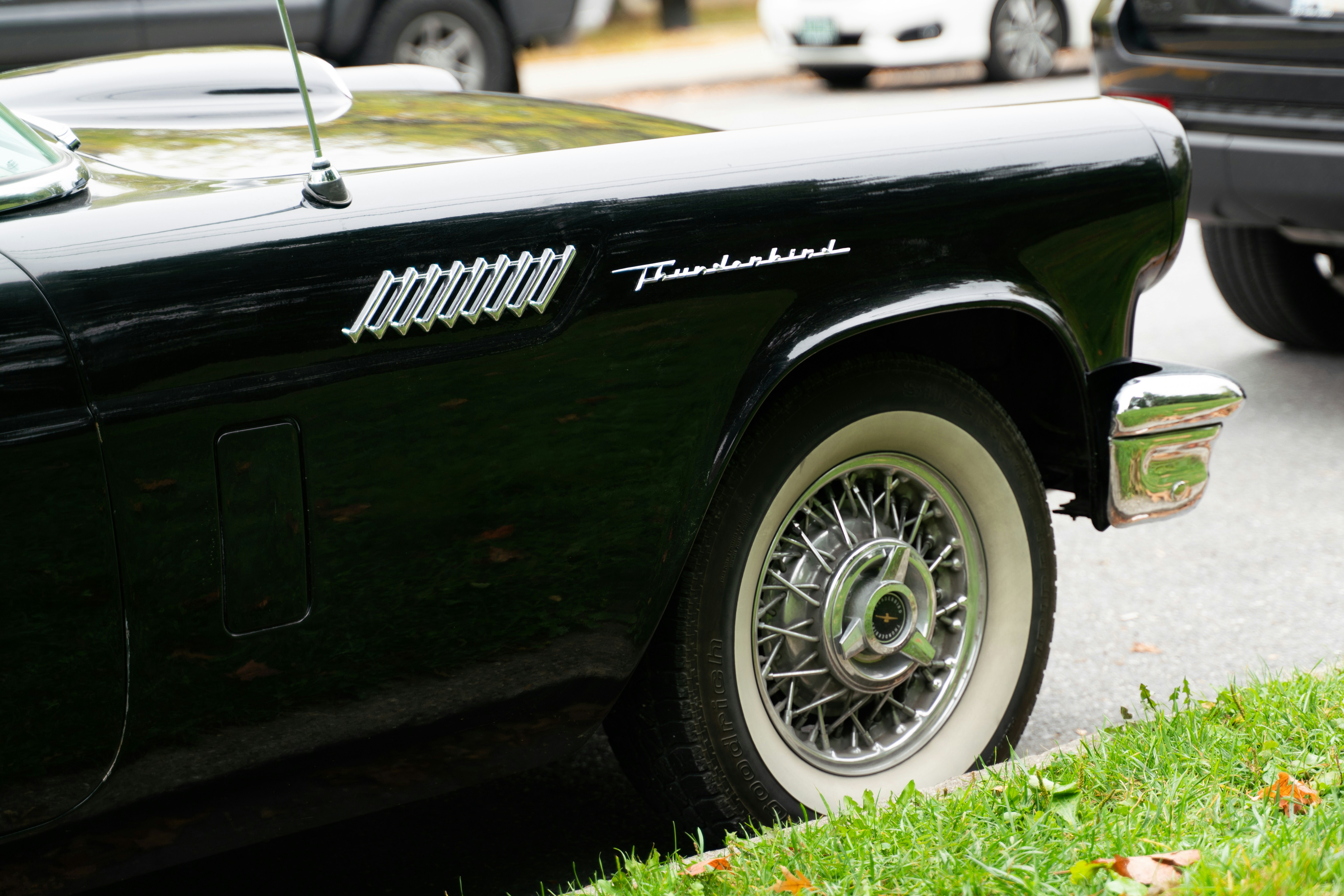 A black car parked on the side of the road