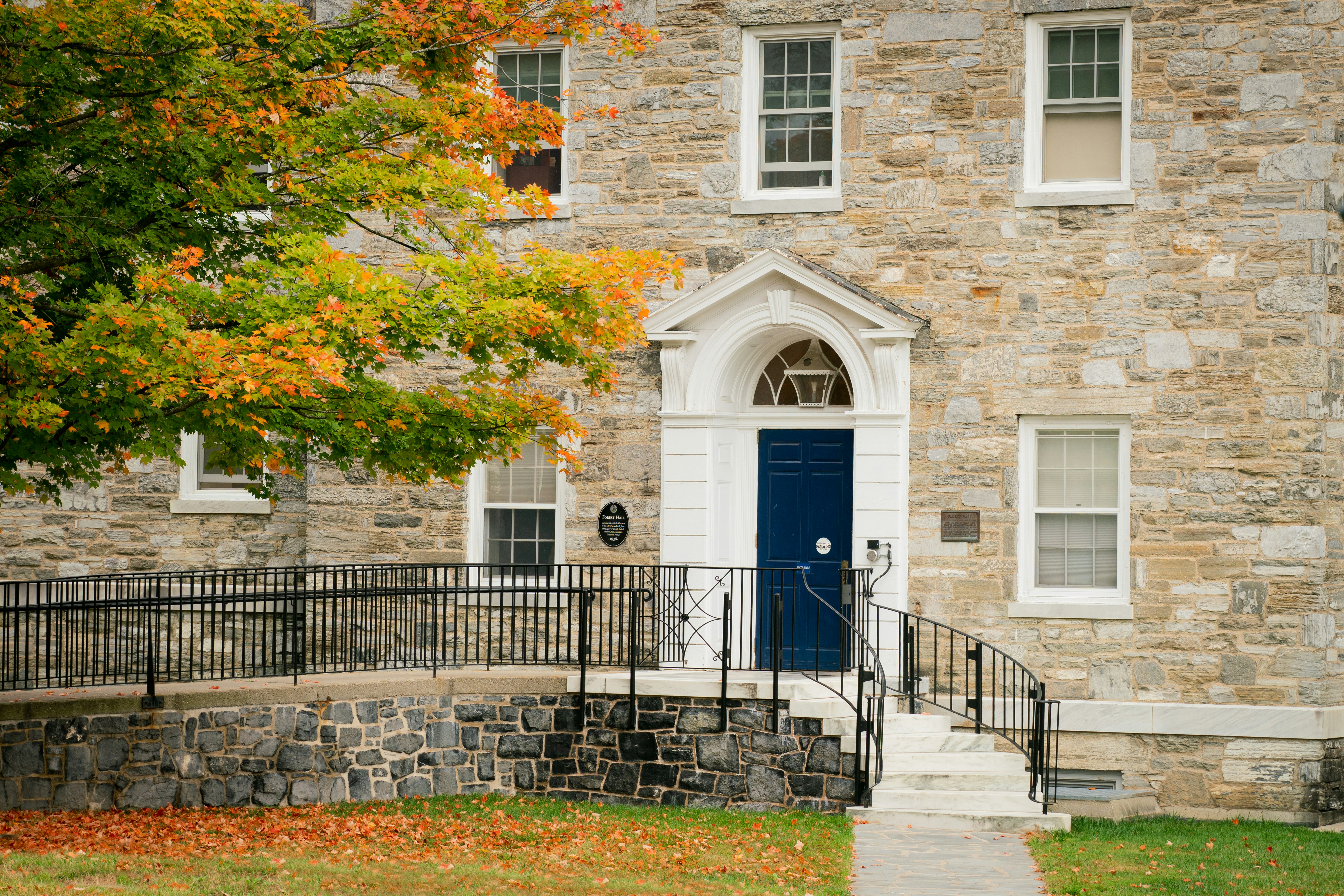 A large stone building with a blue door