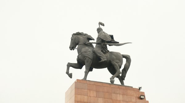 A statue of a man on a horse on top of a building — Bishkek, Kyrgyzstan