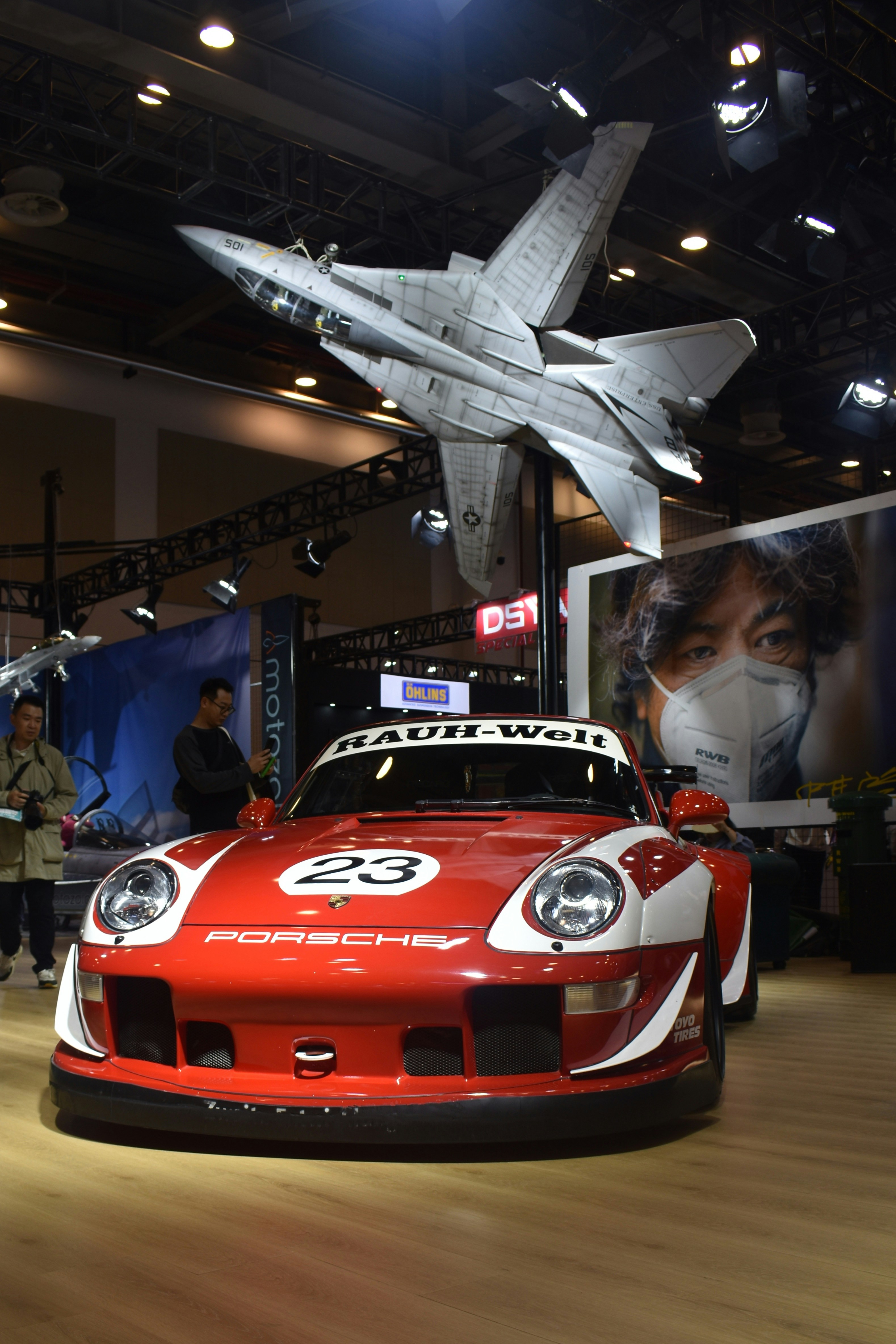 A red sports car on display in a museum