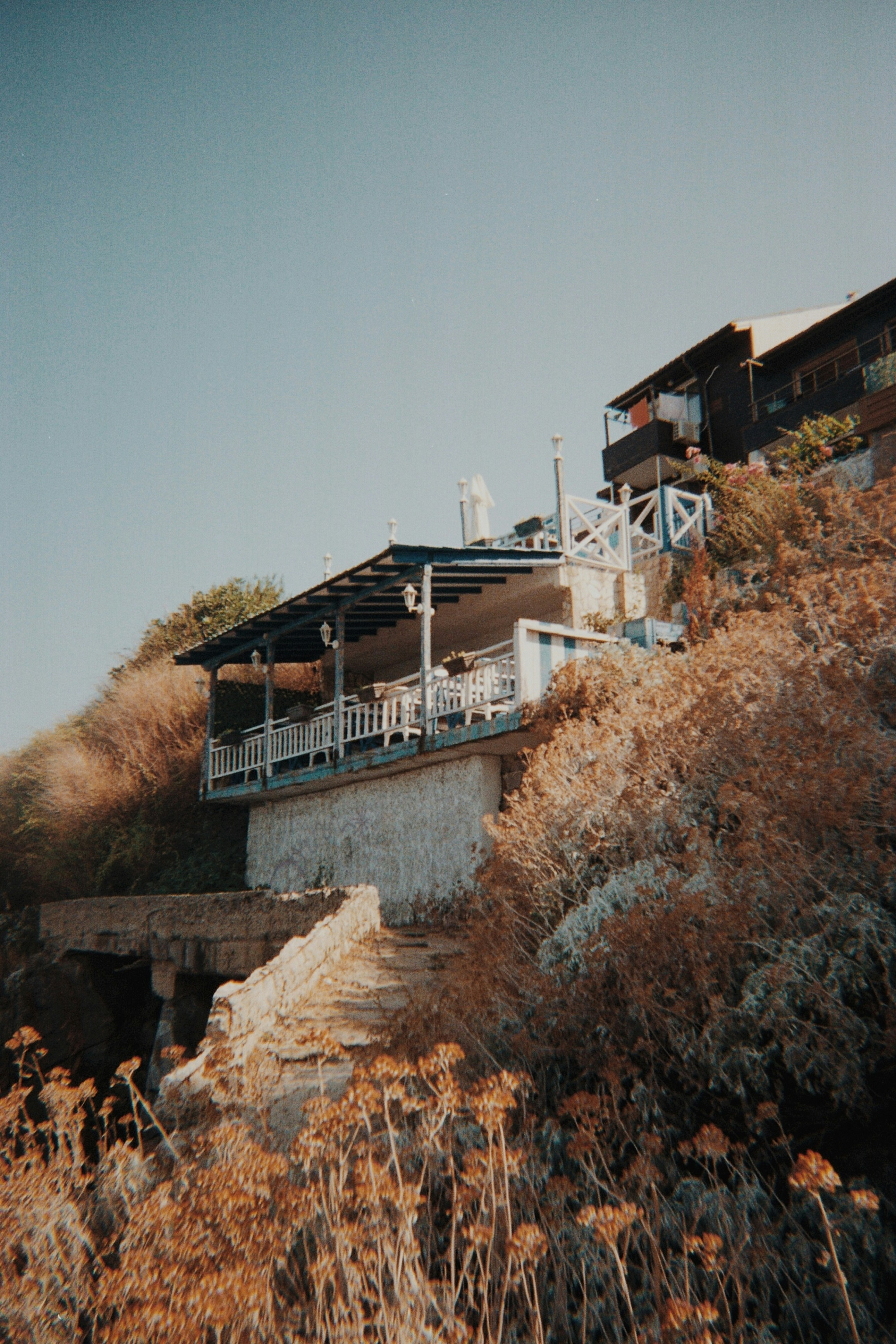 A hillside with a house on top of it