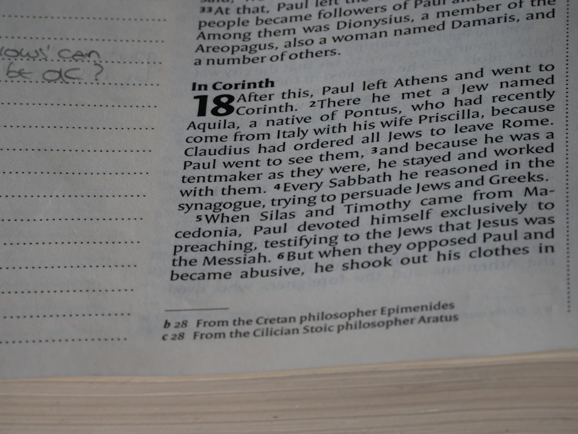 A close up of an open book with writing on it