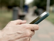 A person holding a cell phone in their hand