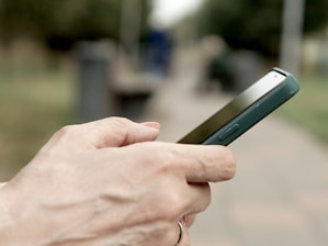 A person holding a cell phone in their hand