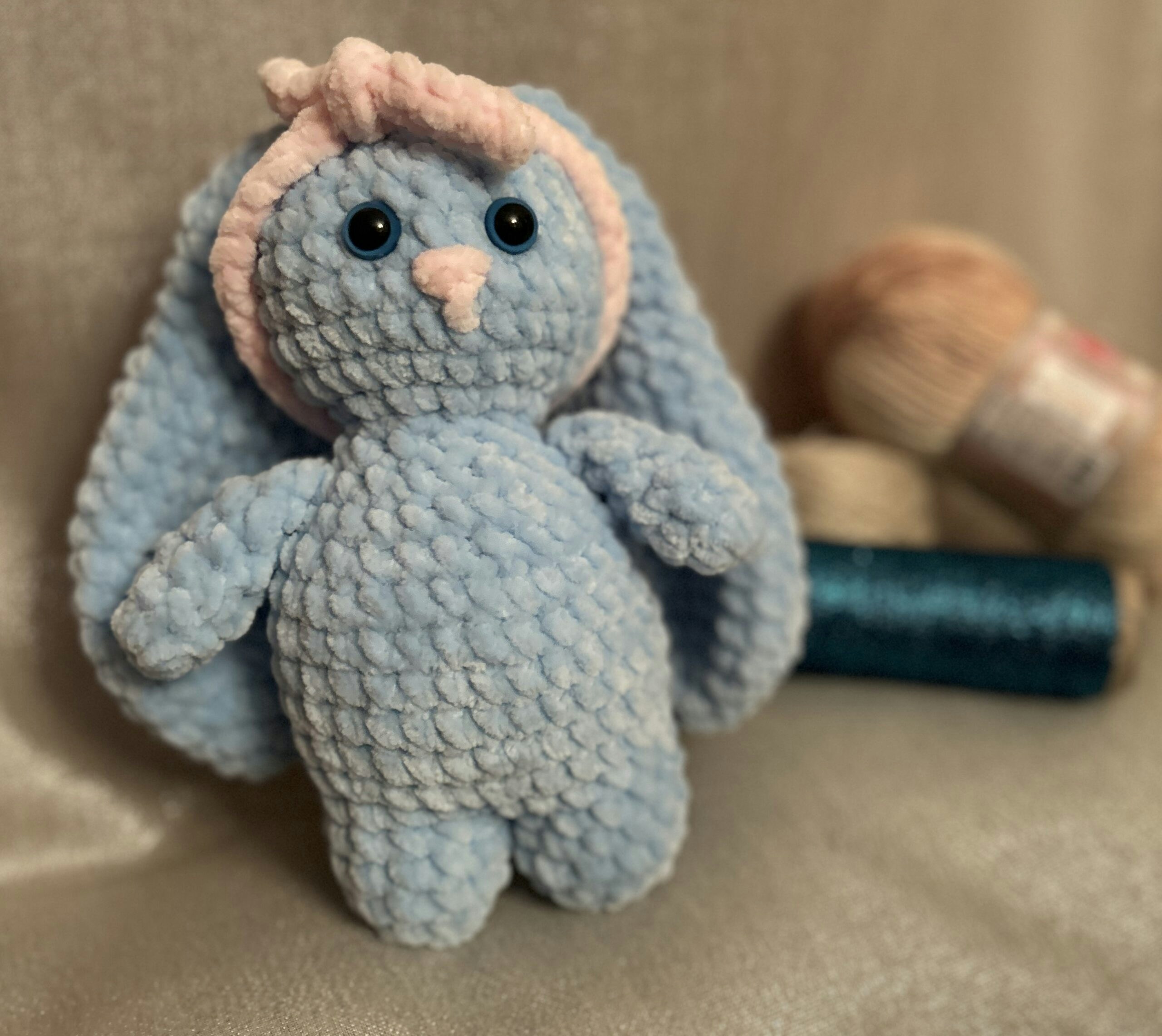 Adorable handmade crochet lavender bunny plushie with pink nose on white background