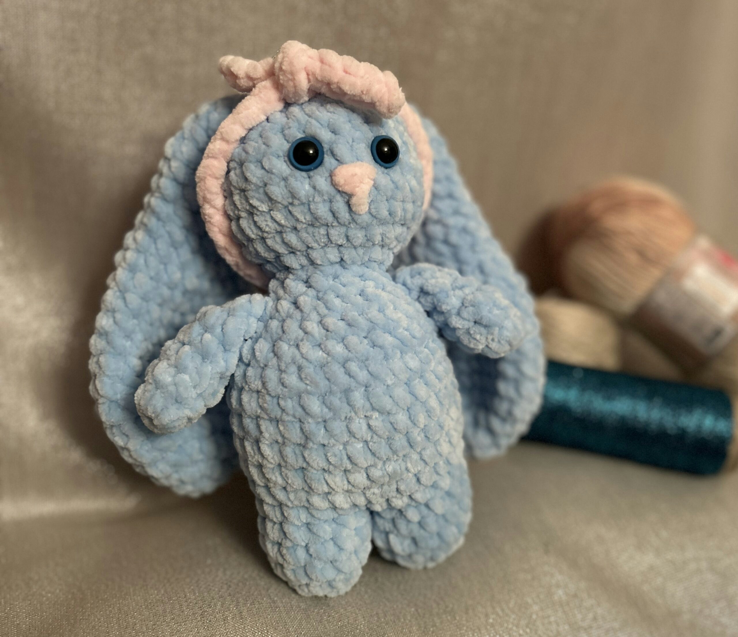 Handmade crochet lavender bunny on soft white background