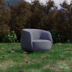 A grey chair sitting on top of a lush green field