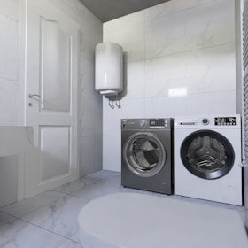 A washer and dryer in a white bathroom