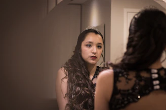 A woman looking at herself in the mirror