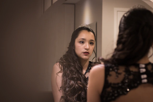 A woman looking at herself in the mirror